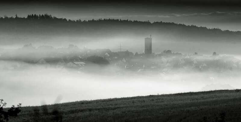 Foggy village at dawn