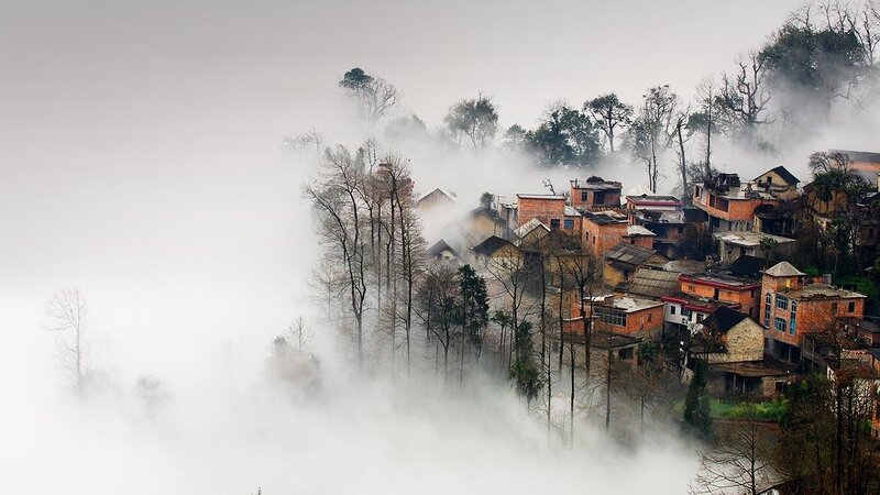 Foggy village on a hillside