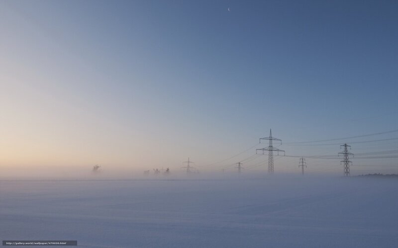 Foggy winter landscape with power lines