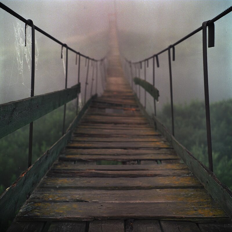Foggy wooden suspension bridge