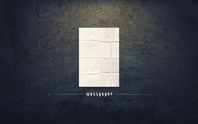 folded paper on concrete wall