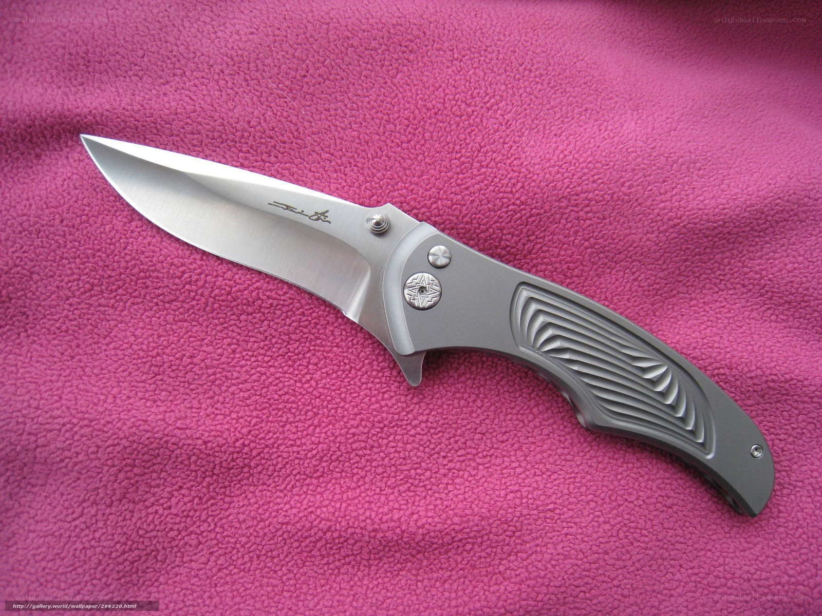 folding knife on pink fabric