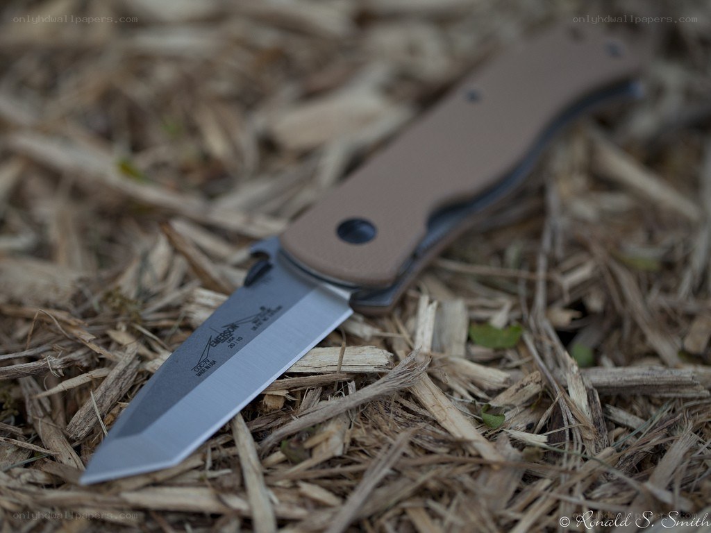 folding knife on wood chips