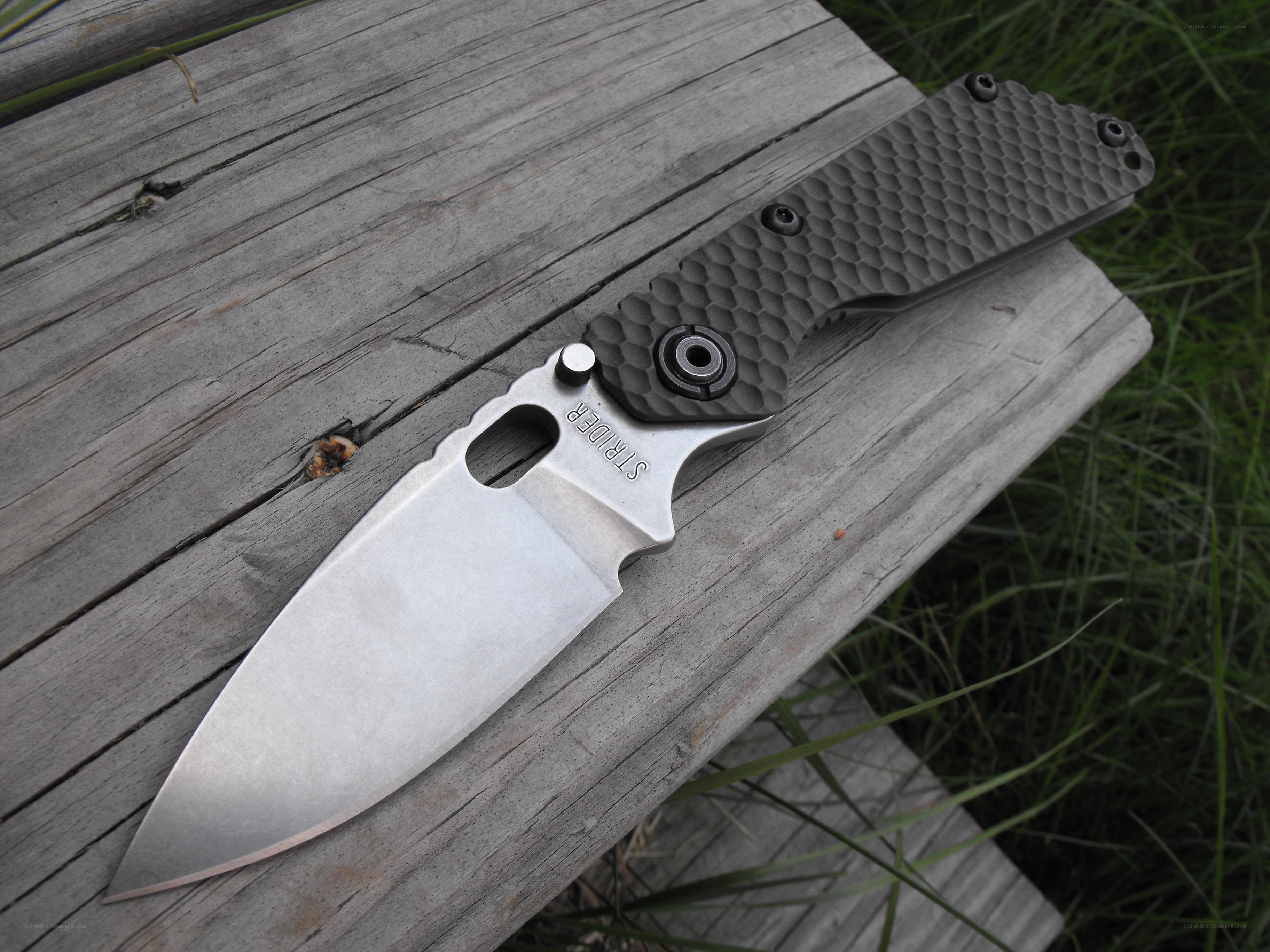 folding knife on wooden surface