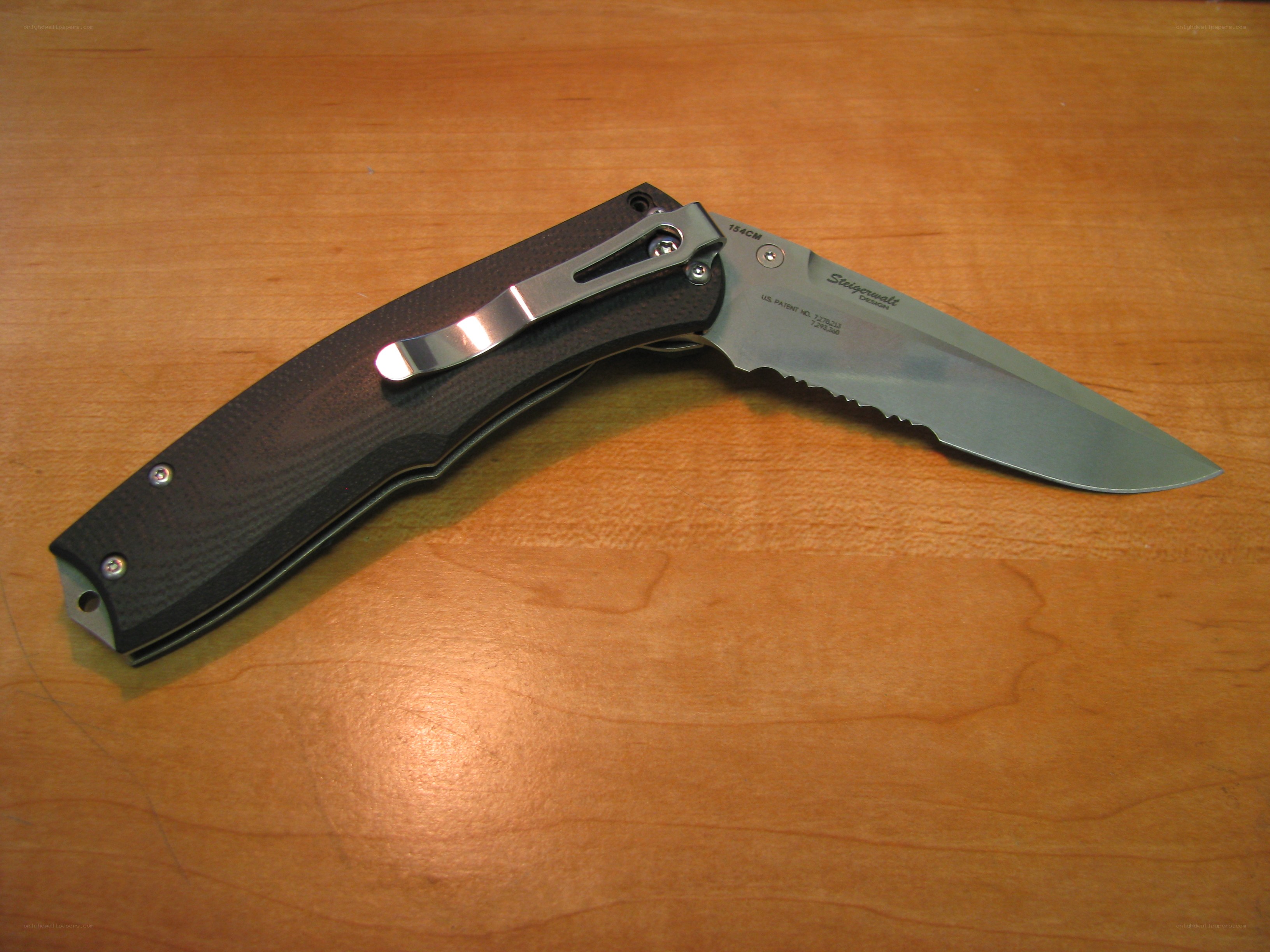 folding knife on wooden surface