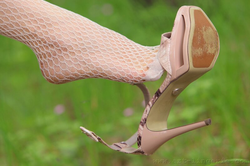 foot in high heels and fishnet stockings