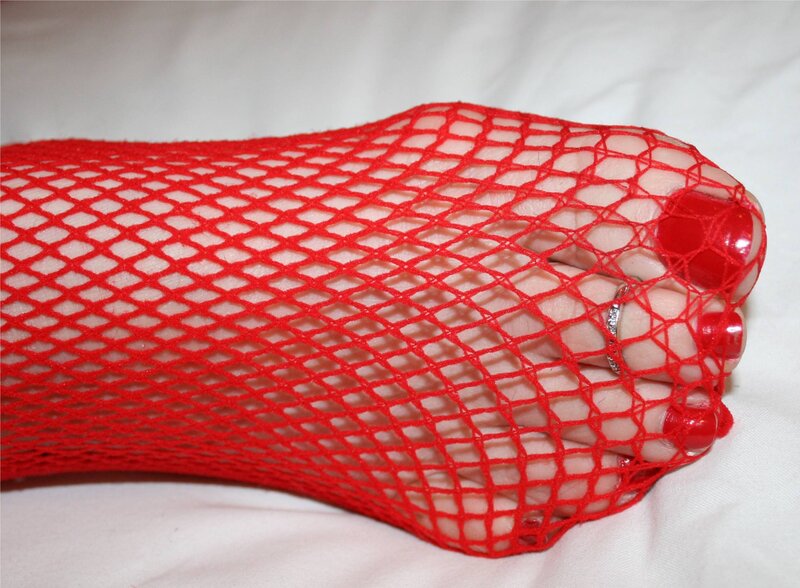 foot in red fishnet stocking