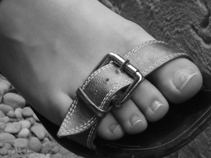 foot in sandal with buckle