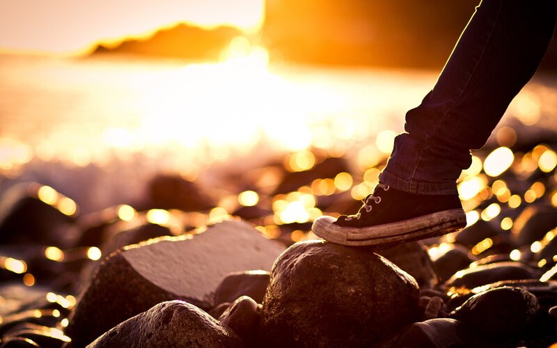 foot on rock at sunset