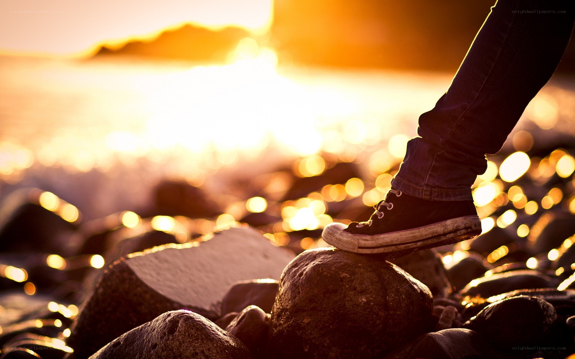 foot on rock at sunset