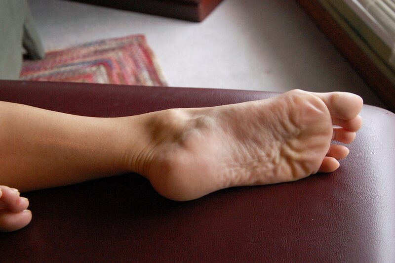 foot resting on leather surface