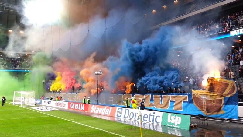 Football fans with smoke bombs