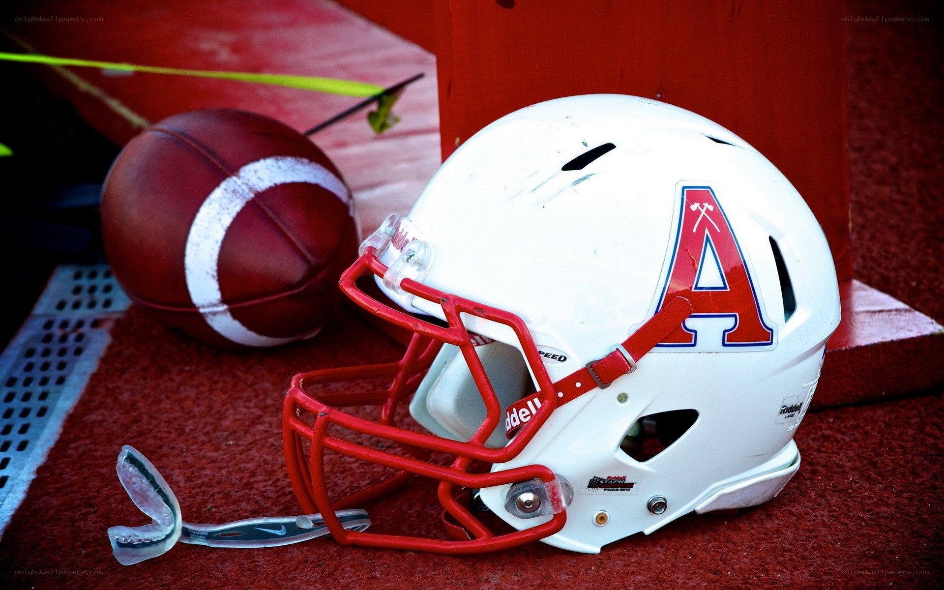 Football helmet and ball on field