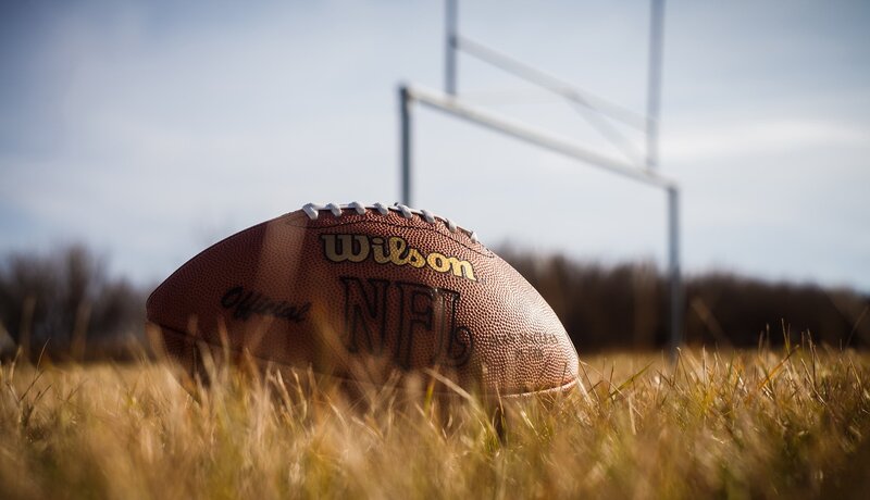 Football on Grass Field — Brown