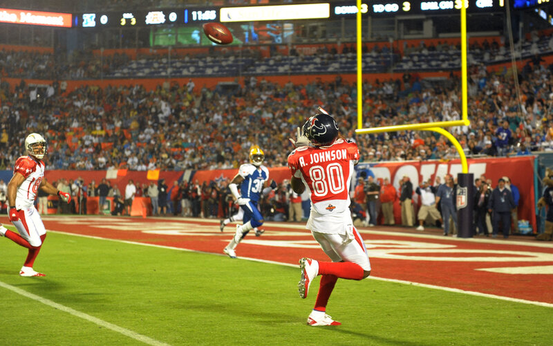 Football Player Catching Ball — Red