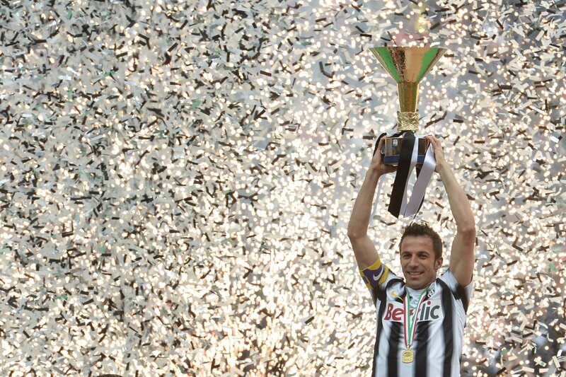Football player celebrates with trophy