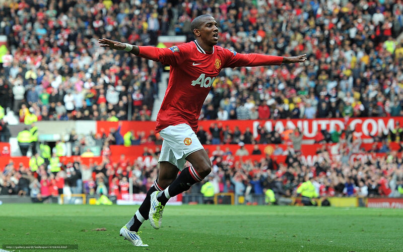 Football Player Celebrating — Red, Energetic, Afternoon, Photograph, Crowd