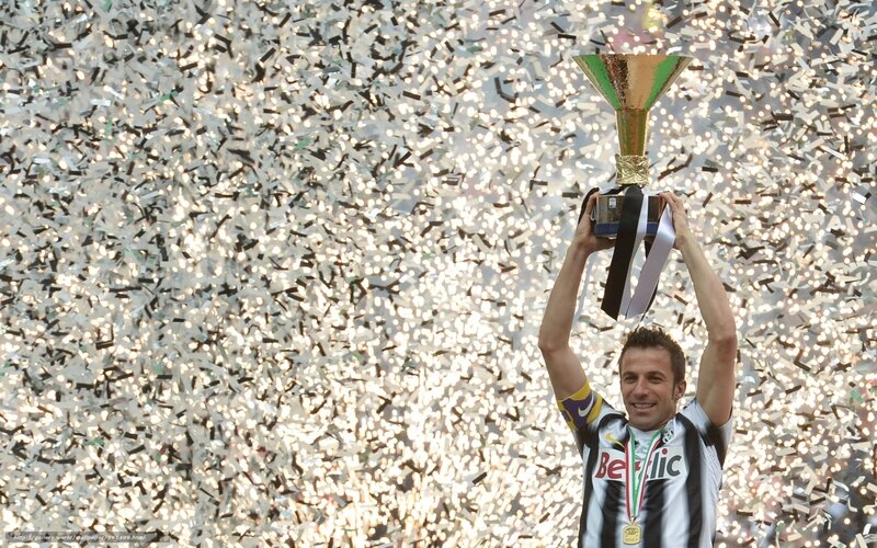 football player celebrating with trophy