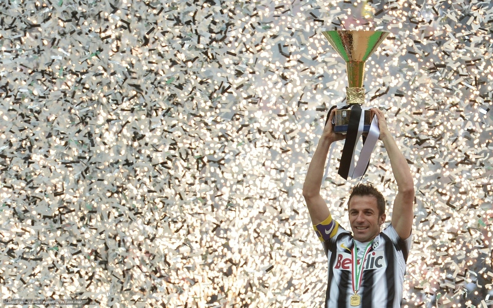 football player celebrating with trophy