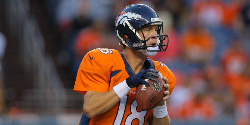 Football Player Holding Ball — Orange, Focused