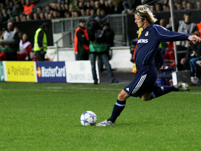 football player kicking ball