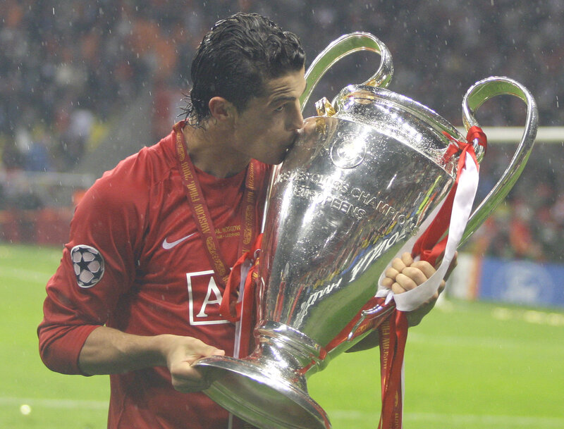 football player kissing trophy