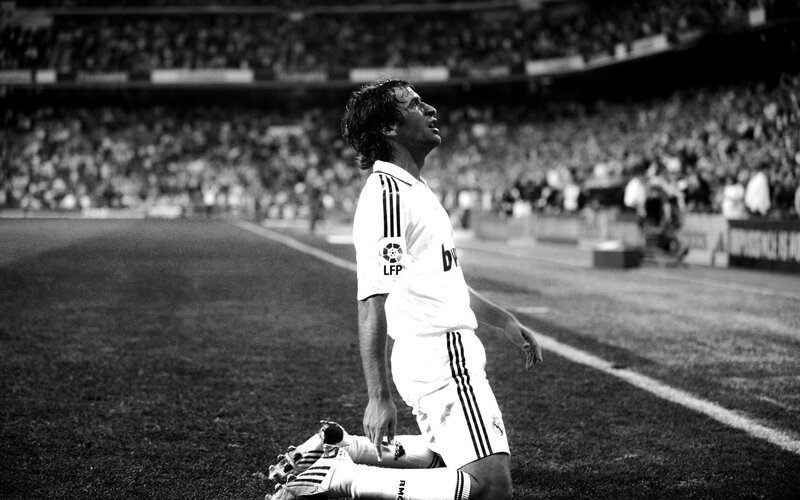 football player kneeling on field