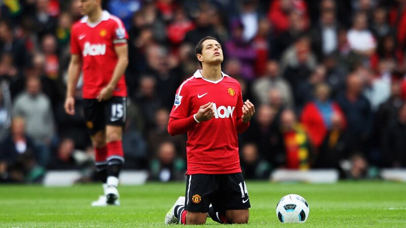 football player kneeling on field