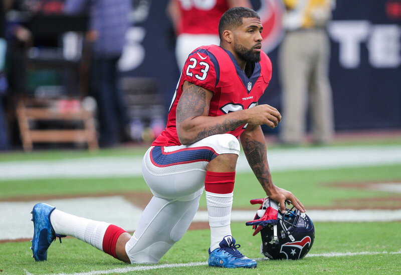football player kneeling on field
