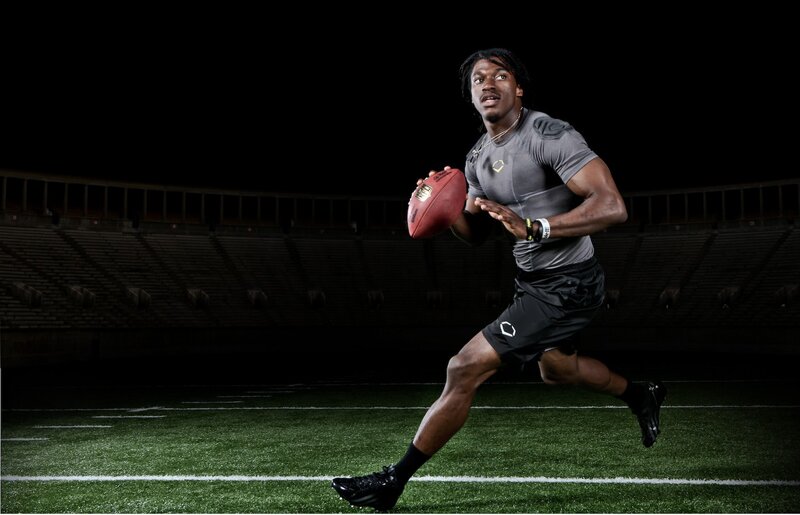 football player running with ball