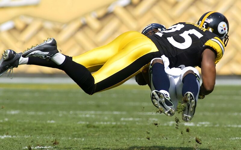 Football player tackling opponent