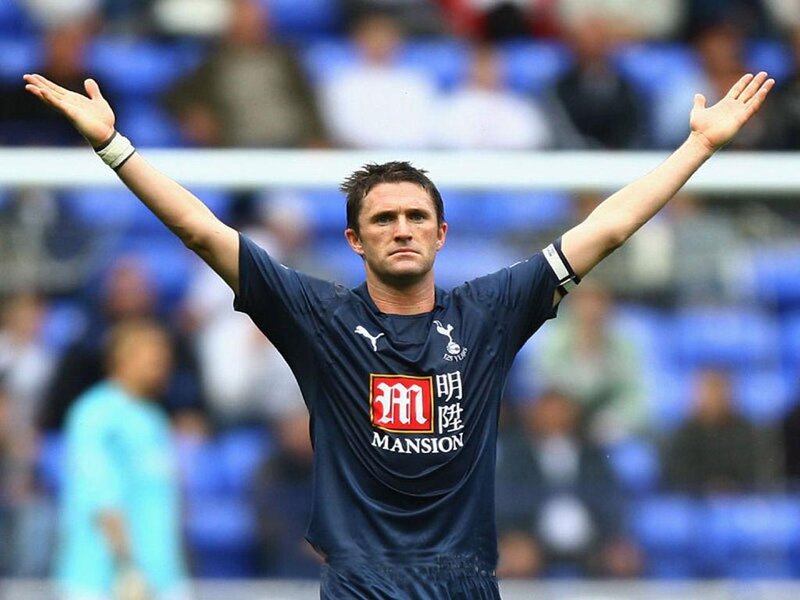 football player with arms raised