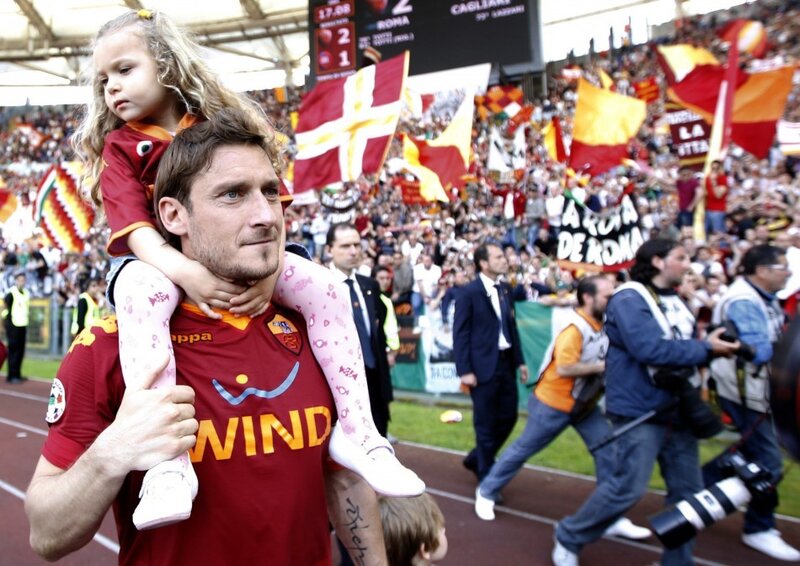Football player with child at stadium