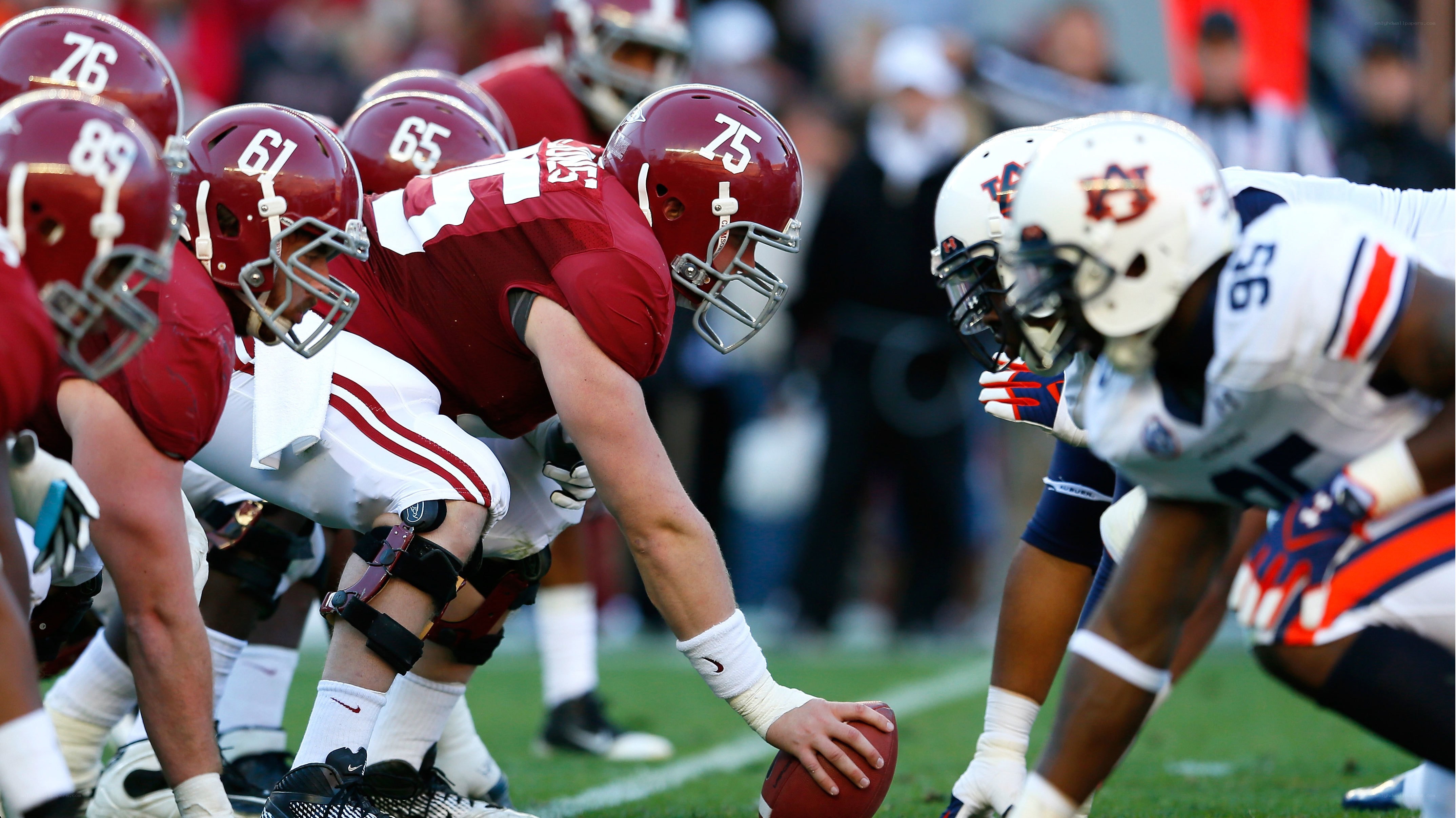 Football players at line of scrimmage