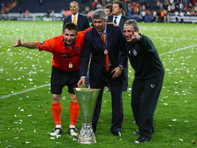 Football players celebrate with trophy