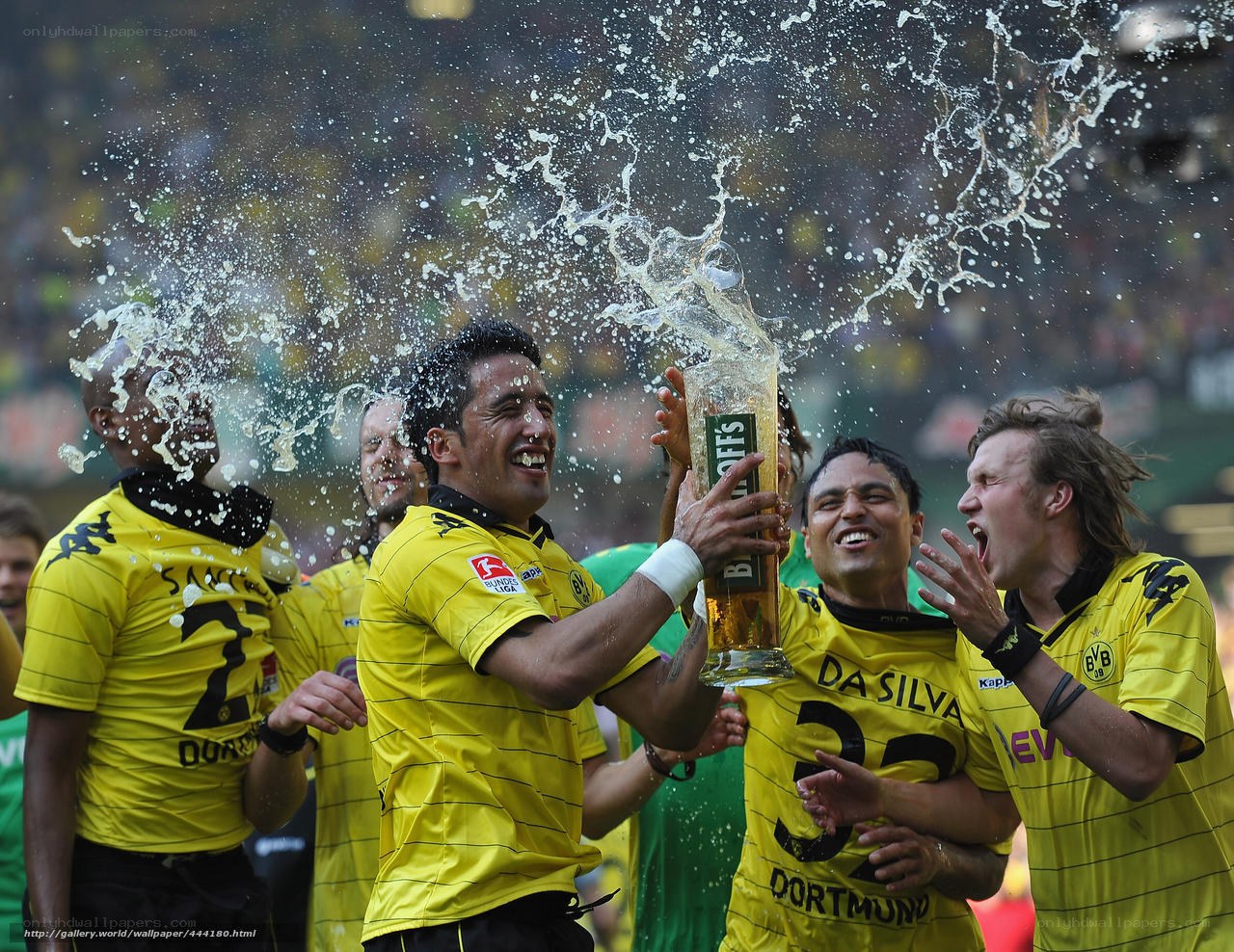 Football players celebrating with beer