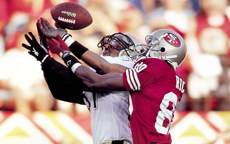 Football players contesting a pass