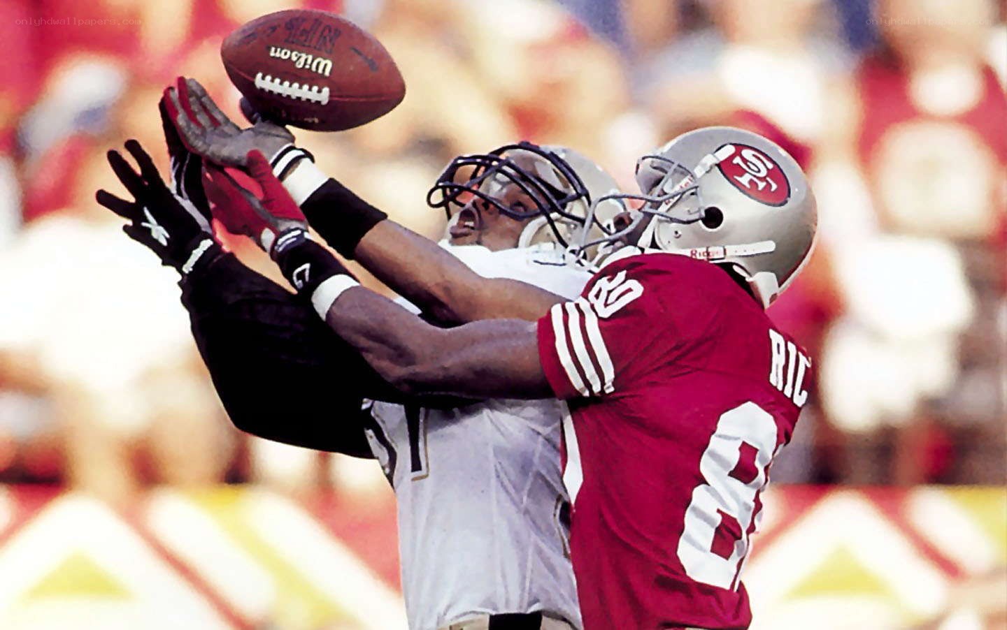 Football players contesting a pass