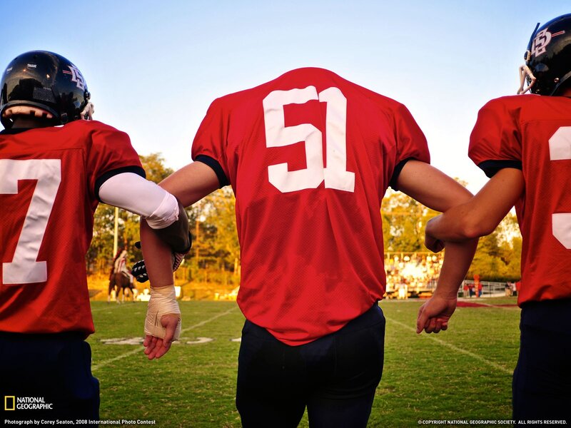 football players in a huddle