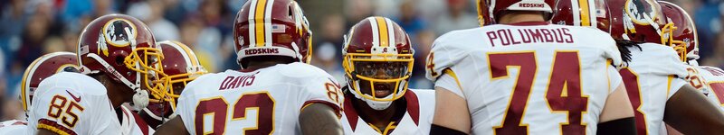 Football Players in Huddle — White