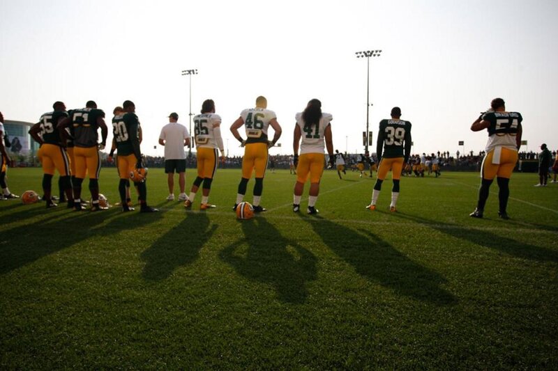 Football Players on Field — Green, Dramatic