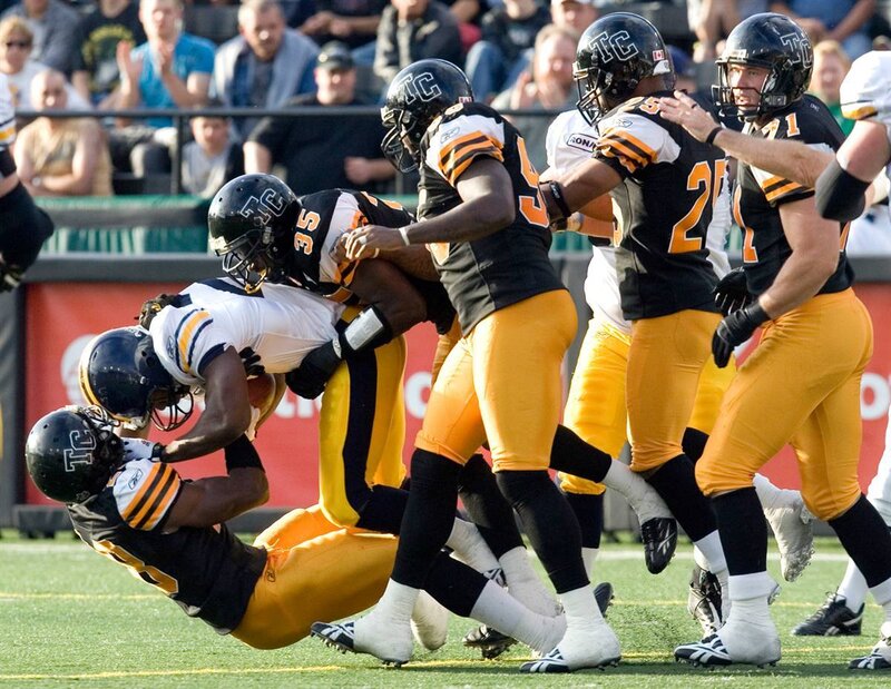 Football tackle in progress