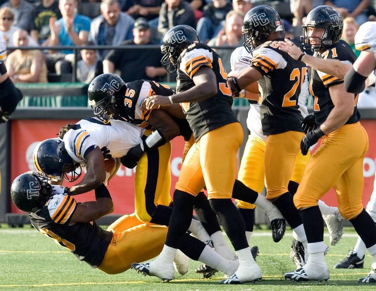 Football tackle in progress