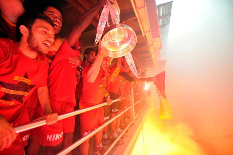 Football team celebrates with trophy
