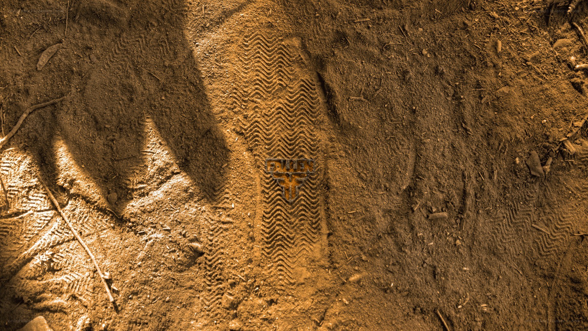 footprint in dirt with logo