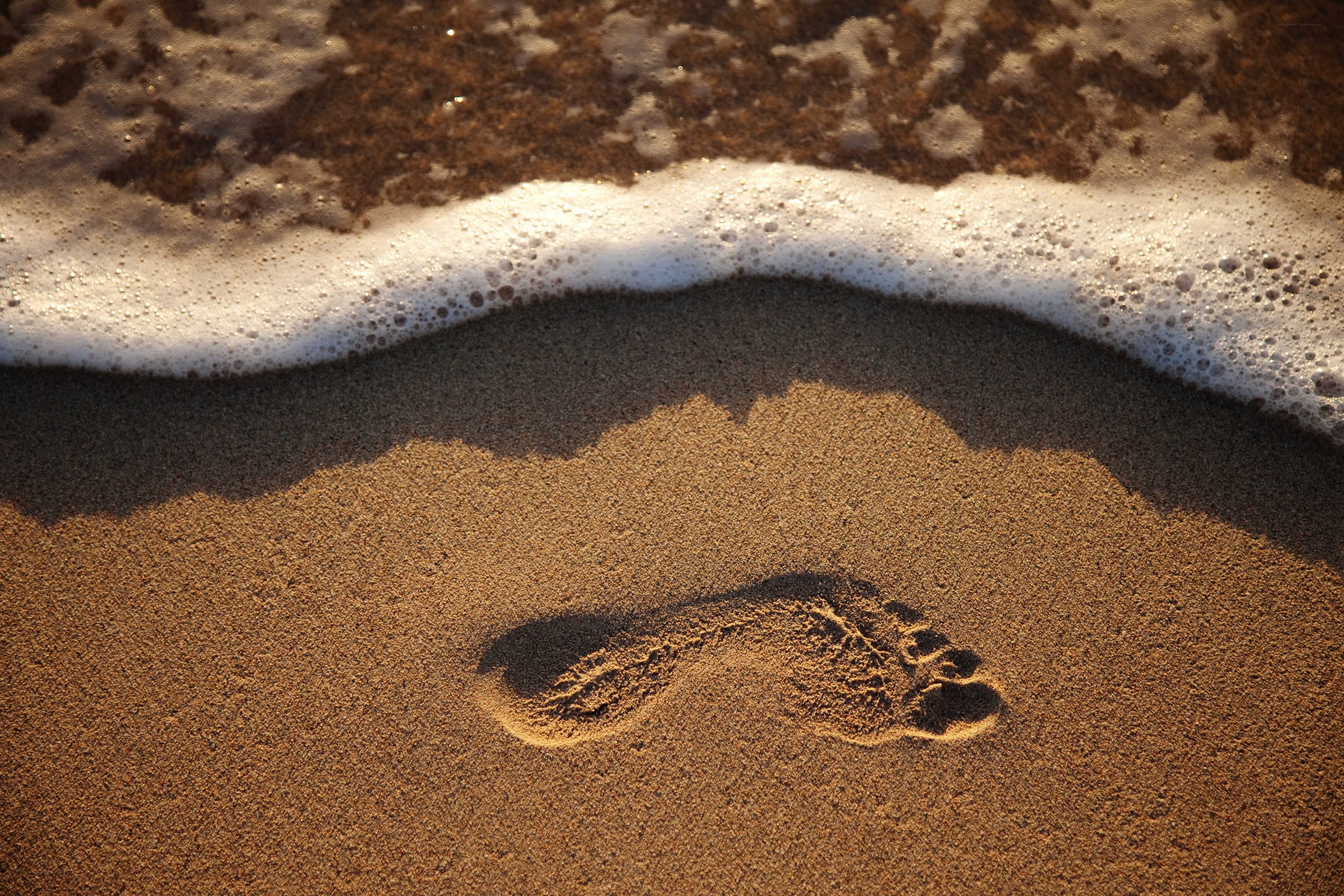 Footprint in the sand at sunset