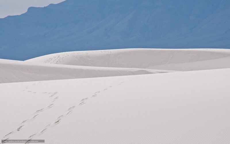 Footprints in white sand dunes