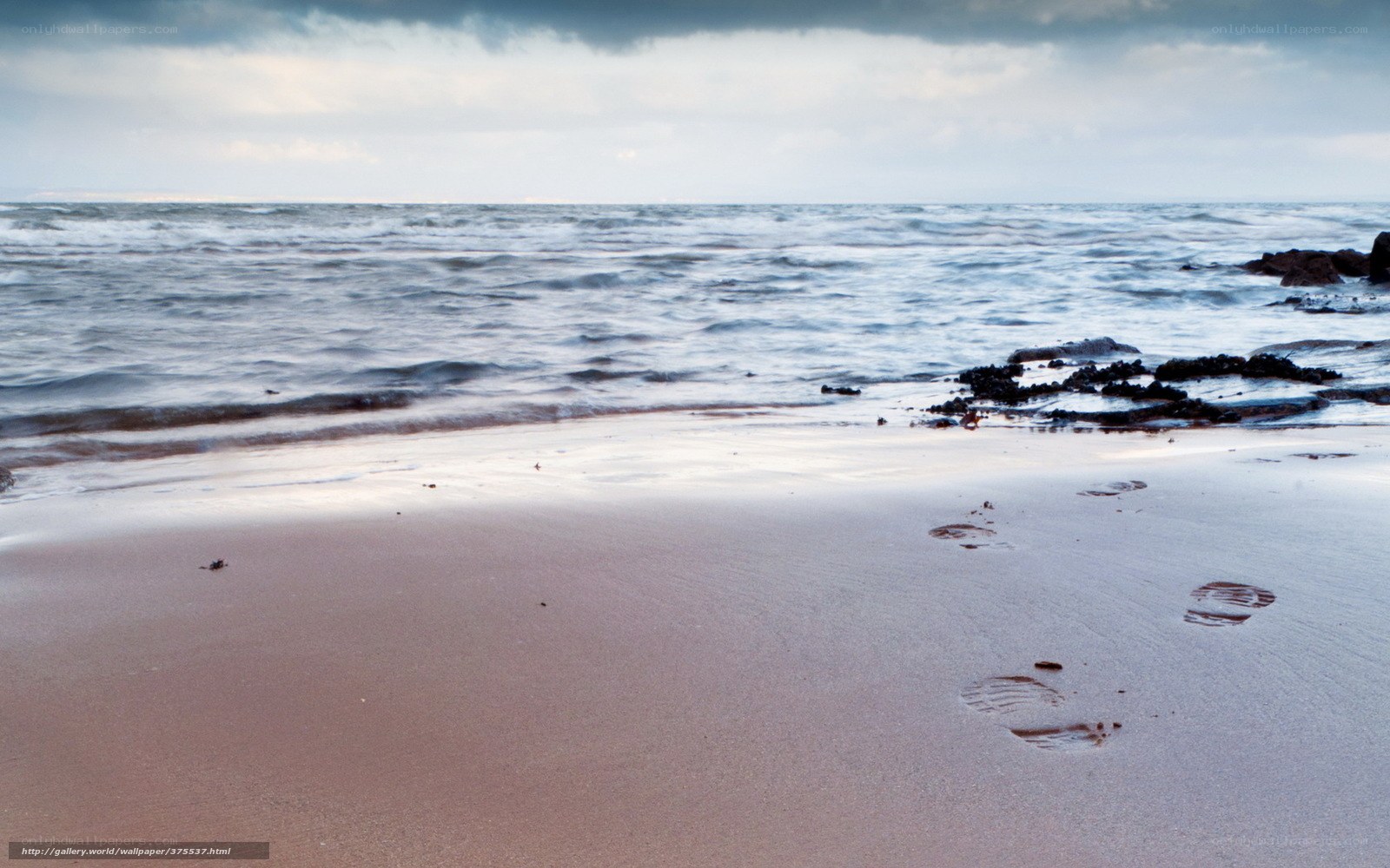 Footprints on a beach at dusk