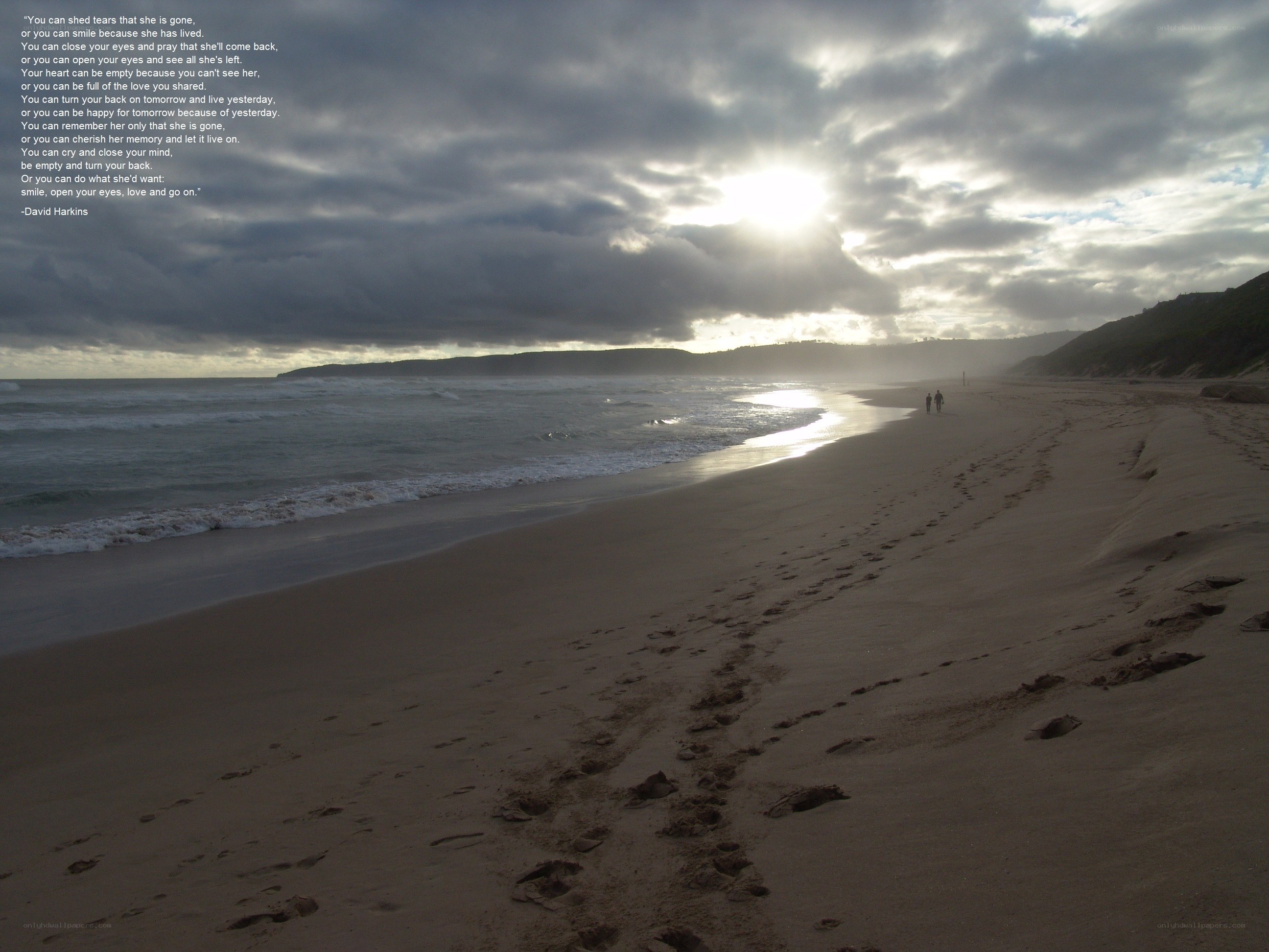 Footprints on a beach at sunset