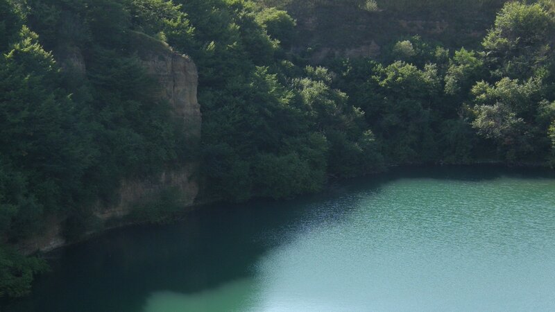 Forest lake with rocky cliff